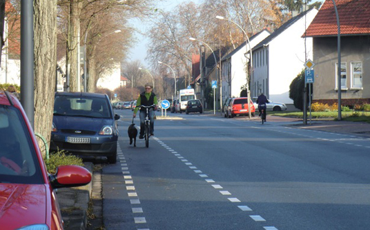 Das Bild zeigt einen Radfahrer auf dem Schutzstreifen